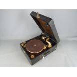 A Columbia Grafonola wind up, portable gramophone with three tins of needles and winder.