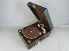 A Columbia Grafonola wind up, portable gramophone with three tins of needles and winder.