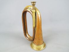 An early 20th century brass mounted, copper bugle.