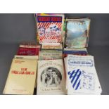 A box of various vintage sheet music.