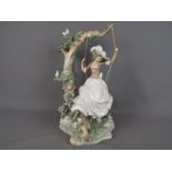 Lladro - A large Lladro figure group depicting a girl on a swing,