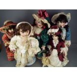 A collection of five beautifully costumed dolls, porcelain heads and hands and fixed glass eyes.