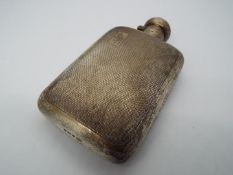 A George V hallmarked silver hip flask with engine turned decoration, Birmingham assay 1920,