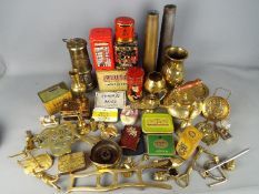 A collection of brassware, shell casings, miner's safety lamp, vintage tins and other.