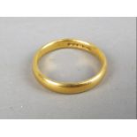 A hallmarked 22ct gold wedding band, size J, approximately 3.33 grams all in.