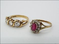 A 9ct gold CZ trilogy ring, size L, and a further 9ct gold cluster ring, size H,