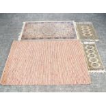 Four rugs of varying size, largest approximately 150 cm x 90 cm.