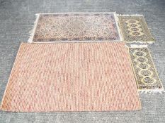 Four rugs of varying size, largest approximately 150 cm x 90 cm.