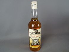A bottle of Claymore 70 cl 40% ABV