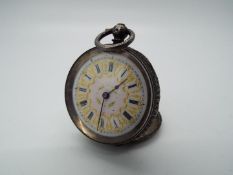 A lady’s silver cased pocket watch, case having engraved decoration,