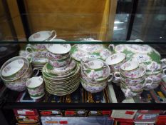 A quantity of Minton dinner and tea wares in the Green Cockatrice pattern including tureens, cups,