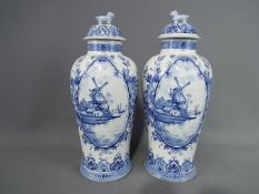 A pair of 20 th century Delft ginger jars and covers, approximately 31 cm (h) including cover.