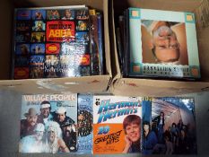 Two boxes of 12" vinyl records, various genres, to include Herman's Hermits, 10cc, Village People,