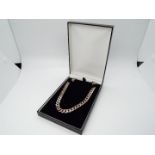 An Italian curb chain necklace, stamped 925, 56 cm (l), approximately 70 grams all in.