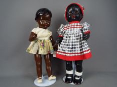 Vintage Dolls - Two black composition dolls. One with painted blue eyes and earrings. 50cm.