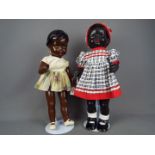Vintage Dolls - Two black composition dolls. One with painted blue eyes and earrings. 50cm.
