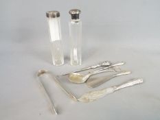 A collection of hallmarked silver items to include commemorative spoon, sugar tongs,
