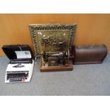 A vintage Singer sewing machine in case, cased Brother typewriter and brass bound fire screen.