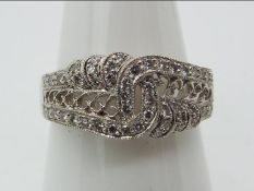 An 18ct white gold, diamond chip encrusted ring, size P+½, approximately 5.3 grams all in.