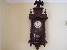 A Vienna style wall clock, opening glazed door flanked by turned columns,