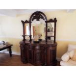 A mahogany Credenza, serpentine fronted with mirrors above, as illustrated,