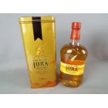 A bottle of Jura 10 year old 70 cl 40% ABV in presentation tin