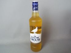 A bottle of Snow Grouse 70 cl 40% ABV