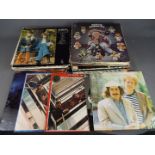 A box of 12" vinyl records to include The Beatles, ABBA, The Eagles, The Moody Blues,