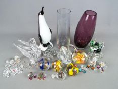 A collection of glassware to include paperweights, animal figurines, vases,