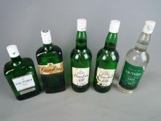 Five 1 litre bottles of gin to include London Silk, Gordons and Victory.