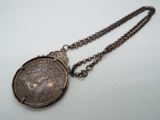 A mounted 1881 'Morgan' silver dollar on chain stamped 'Sterling', Philadelphia Mint.