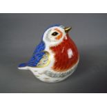 A Royal Crown Derby robin with gold stopper,