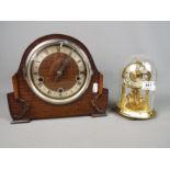 An Enfield oak cased mantel clock, Roman numerals to a silvered chapter ring,