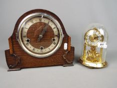 An Enfield oak cased mantel clock, Roman numerals to a silvered chapter ring,