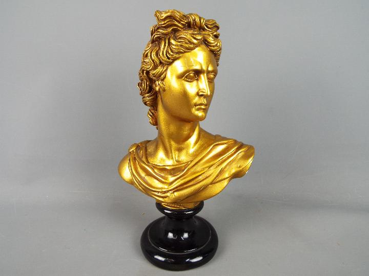 A plaster bust of Apollo finished in a gold colourway, approximately 32 cm (h).