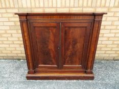 A William IV large twin door cupboard measuring approximately 102 cm x 106 cm x 50 cm.