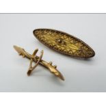 A Victorian navette shaped 15ct gold wirework brooch and a further yellow metal 'Wishbone' brooch,