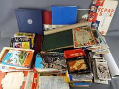 A collection of vintage ordnance survey maps, scrap books, stamps, cricket score books, postcards,
