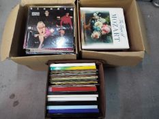 Three boxes of 12" vinyl records, various genres, to include Stevie Wonder, Boney M,