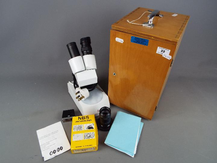 A Brunel Microscopes Ltd stereo microscope contained in wooden case.