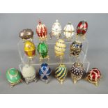 Fifteen enamelled and stone set egg trinkets boxes from the Atlas Editions 'History of the Faberge