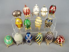 Fifteen enamelled and stone set egg trinkets boxes from the Atlas Editions 'History of the Faberge