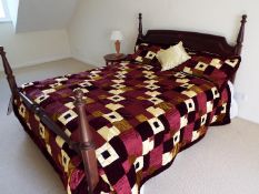 A mahogany king-size bed with quilt as illustrated