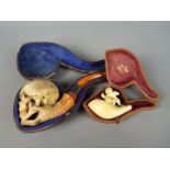 A large early 20 th century meerschaum pipe in the form of a skull, having silver hallmarked collar,