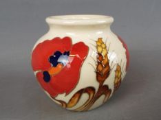 A Moorcroft vase in the Harvest Poppy design, approx height 7.