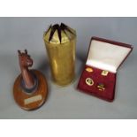 A small lot of collectables comprising a World War One trench art shell decorated with vases of