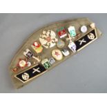 A collection of Soviet Russian badges displayed on a Russian military beret together with three