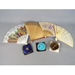 Three vintage powder compacts, two Stratton examples and a Melissa and four folding fans.