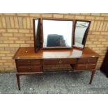 A dressing table with four drawers and triptych mirror arrangement measuring approximately 71 cm
