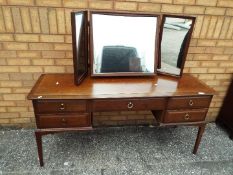 A dressing table with four drawers and triptych mirror arrangement measuring approximately 71 cm